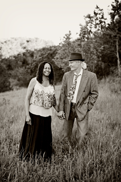 Couple holding hands in meadow, mountains